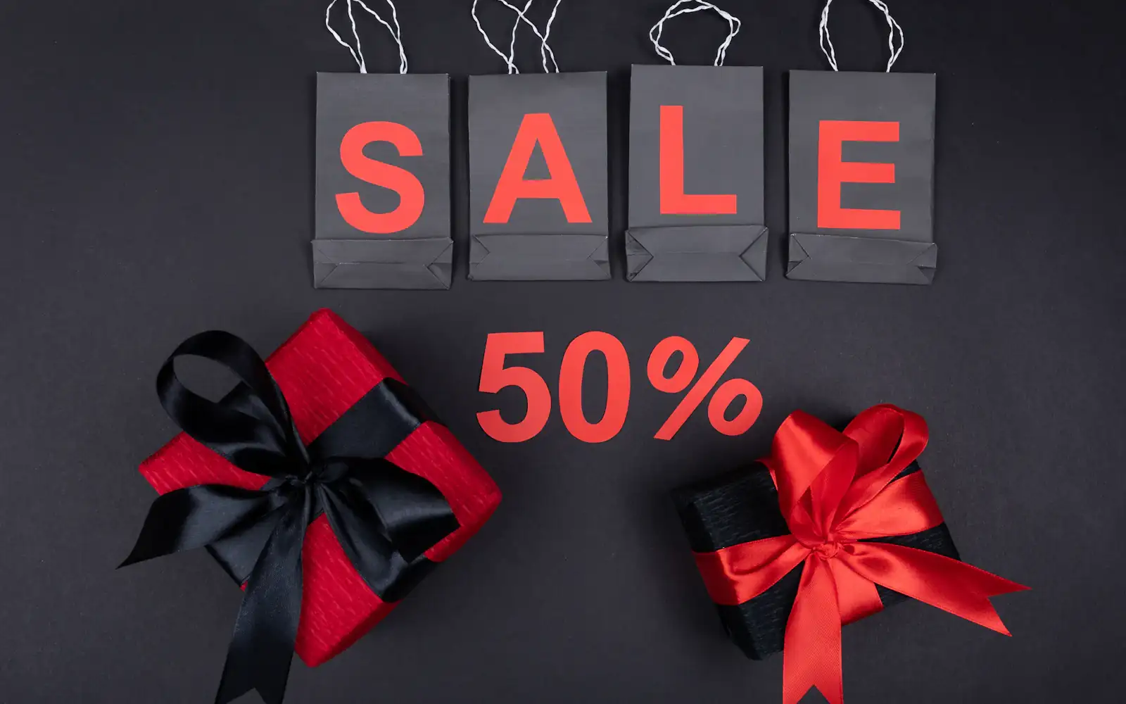 Sale signage and gift boxes in festival red and black
