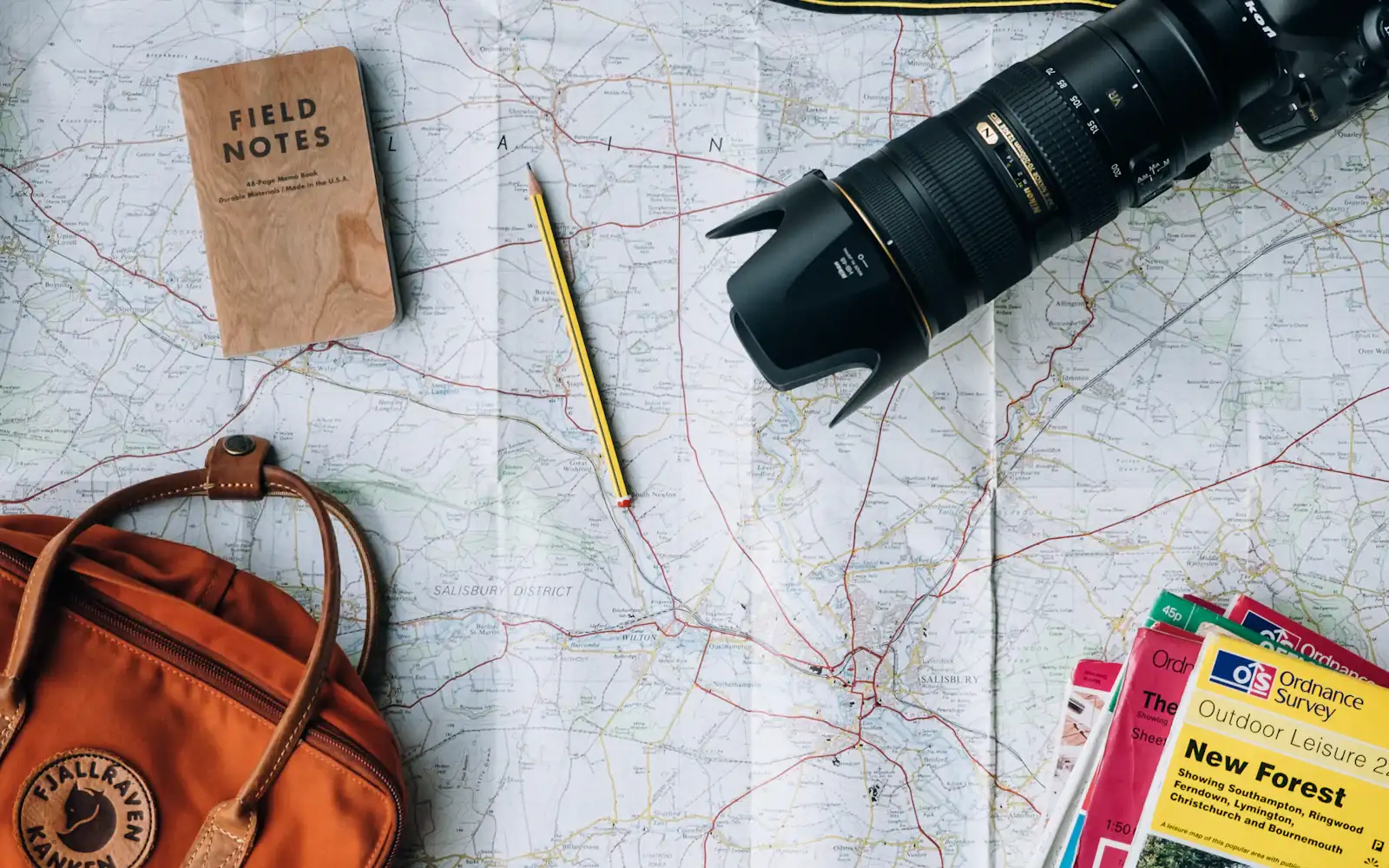 Trip planning with a map, camera and guidebooks